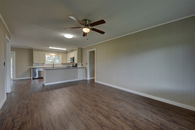 unfurnished living room with crown molding, ceiling fan, and dark hardwood / wood-style floors