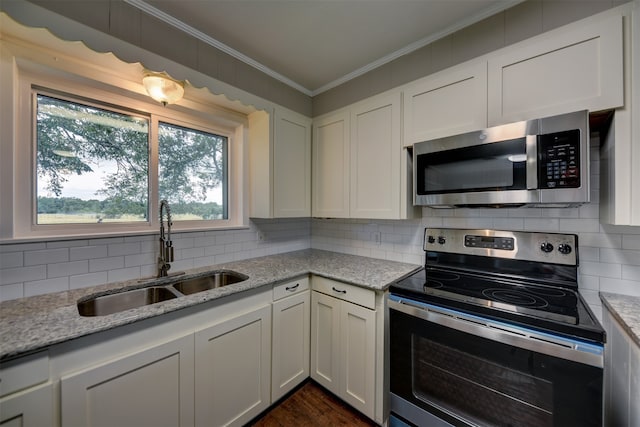 kitchen featuring white cabinets, appliances with stainless steel finishes, sink, and light stone countertops