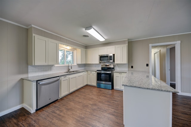 kitchen with dark hardwood / wood-style flooring, stainless steel appliances, sink, light stone counters, and white cabinets