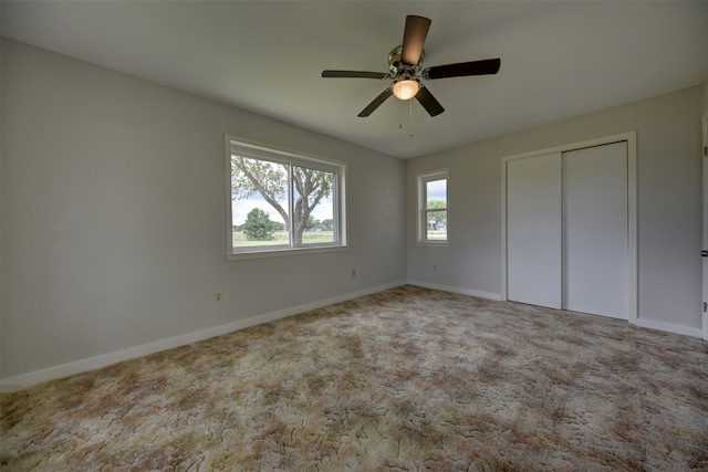 unfurnished bedroom featuring a closet, ceiling fan, and carpet floors