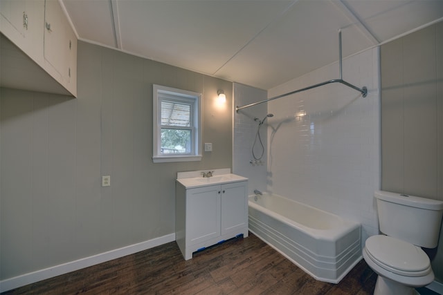 full bathroom with toilet, hardwood / wood-style flooring, tiled shower / bath, and vanity