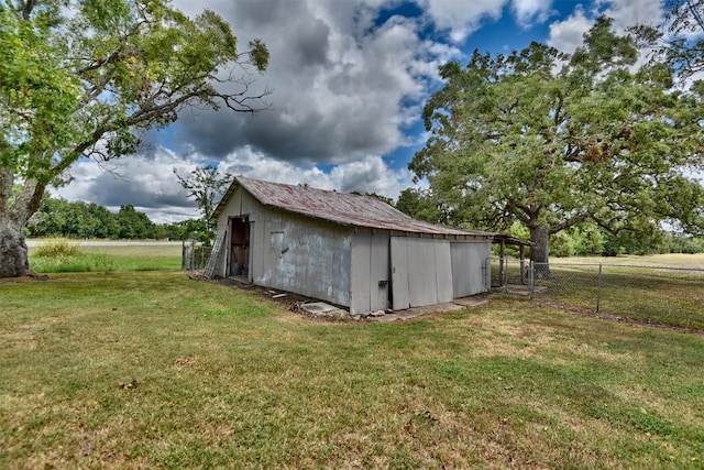 view of outdoor structure with a yard and a rural view