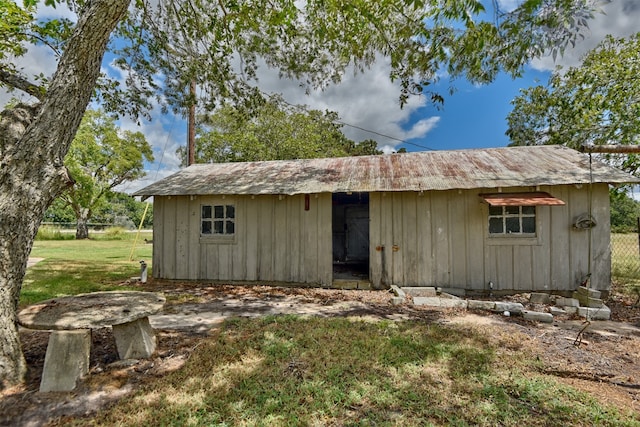 view of outbuilding featuring a lawn