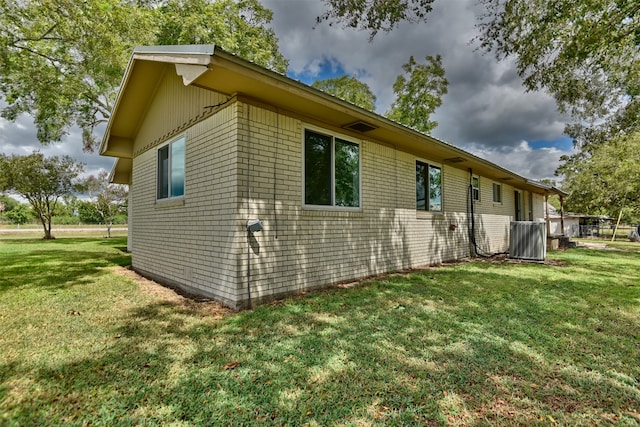 view of side of property with a lawn