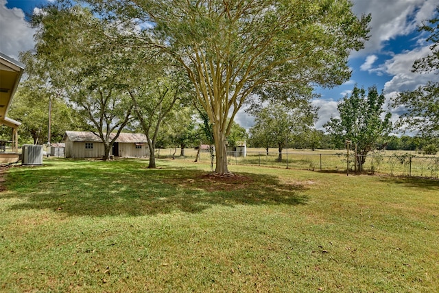 view of yard with a rural view and a storage unit