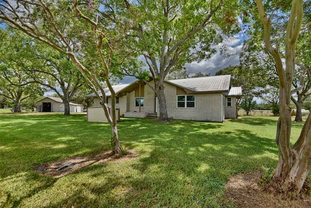 rear view of property with a yard