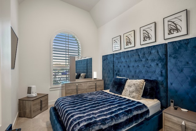 carpeted bedroom with vaulted ceiling