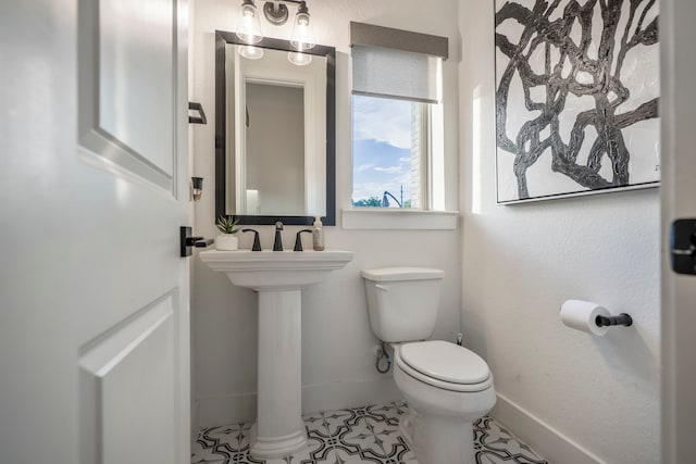 bathroom with toilet and tile patterned floors