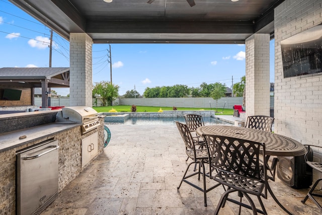 view of patio with a fenced in pool, a grill, and an outdoor kitchen