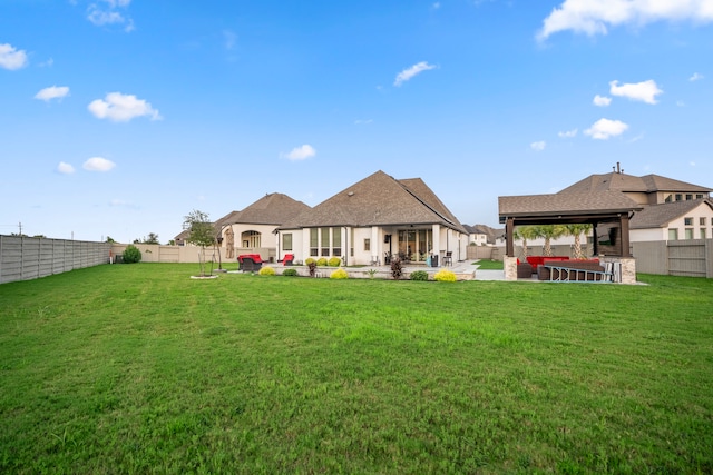 back of property featuring a gazebo, a yard, and a patio area