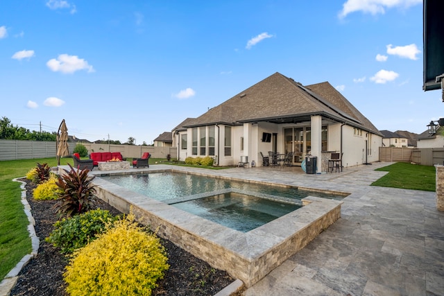 view of swimming pool with an in ground hot tub, a yard, and a patio