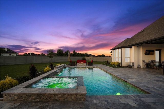 view of pool featuring an in ground hot tub, a patio, pool water feature, and a lawn