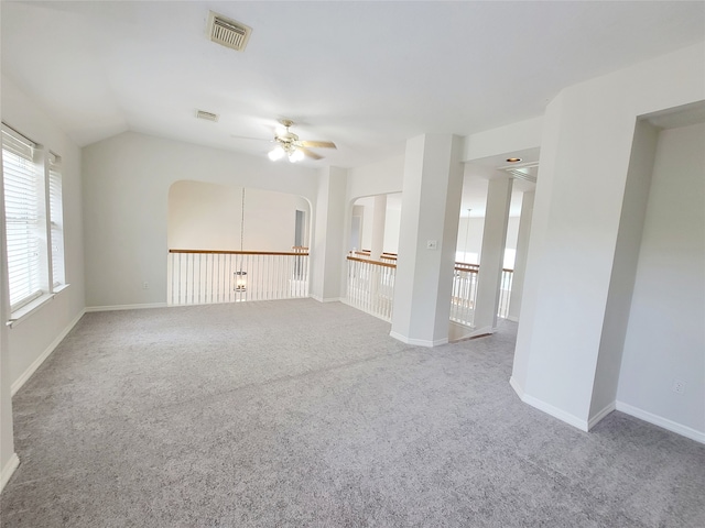 unfurnished room with lofted ceiling, carpet, and ceiling fan