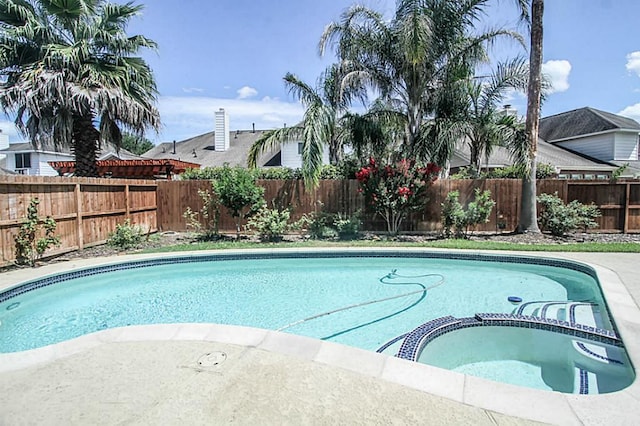 view of swimming pool with an in ground hot tub