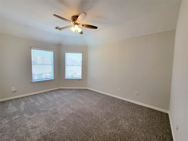 unfurnished room with lofted ceiling, dark carpet, and ceiling fan