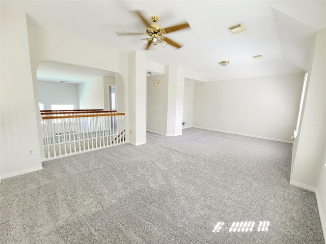 carpeted spare room featuring ceiling fan