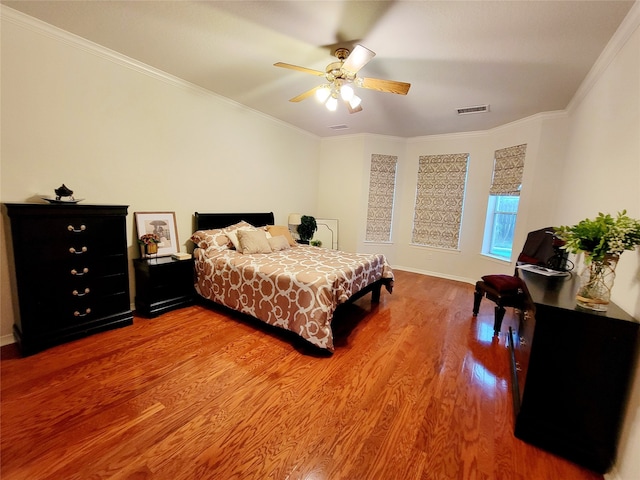 bedroom with ornamental molding, hardwood / wood-style flooring, and ceiling fan