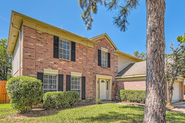 view of front of home with a garage and a front lawn