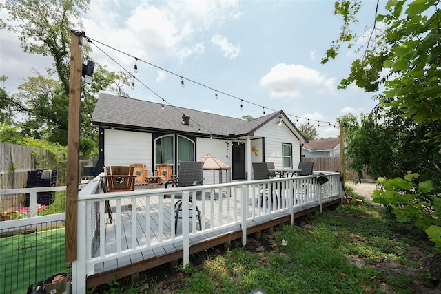 rear view of property featuring a deck