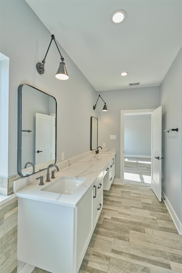 bathroom with vanity and hardwood / wood-style floors