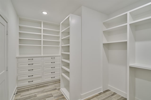 spacious closet with light hardwood / wood-style floors