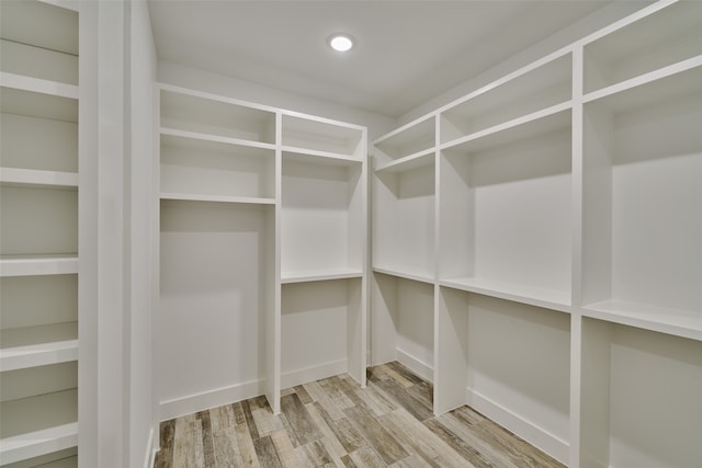 spacious closet with light hardwood / wood-style floors