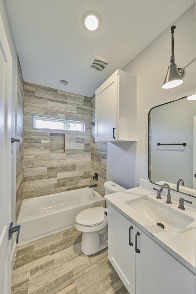 full bathroom featuring vanity, toilet, hardwood / wood-style floors, and tiled shower / bath