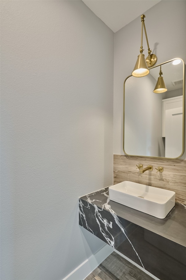 bathroom with wood-type flooring and sink