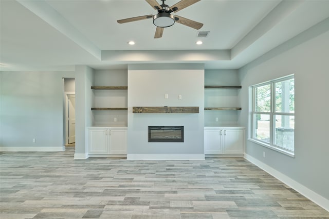 unfurnished living room featuring light hardwood / wood-style flooring and ceiling fan