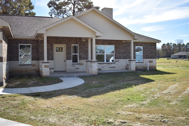 view of front of property with a front lawn and covered porch