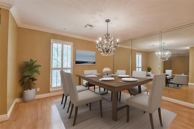 dining area featuring light hardwood / wood-style floors, ornamental molding, and plenty of natural light