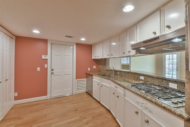 kitchen with appliances with stainless steel finishes, white cabinetry, sink, and light wood-type flooring