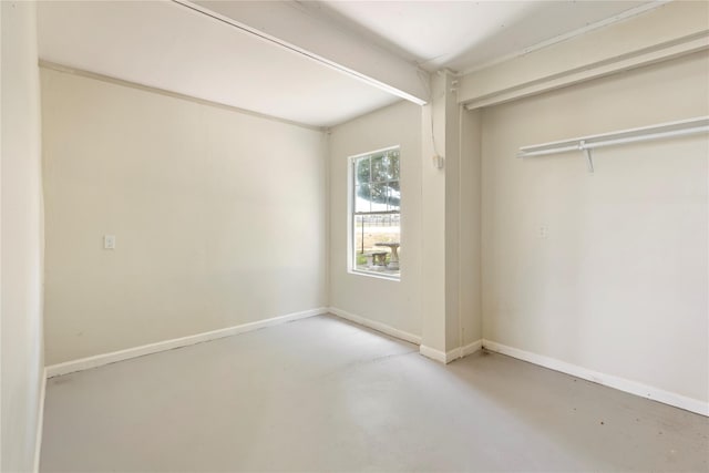 unfurnished bedroom featuring a closet and concrete floors