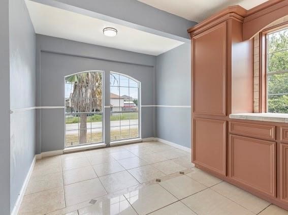 doorway to outside featuring light tile patterned floors