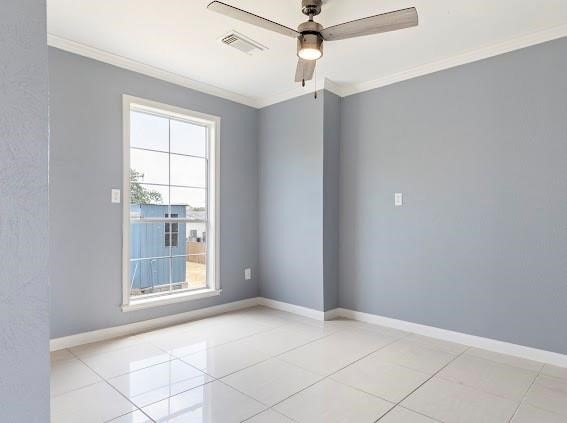 empty room with ornamental molding, light tile patterned flooring, and ceiling fan