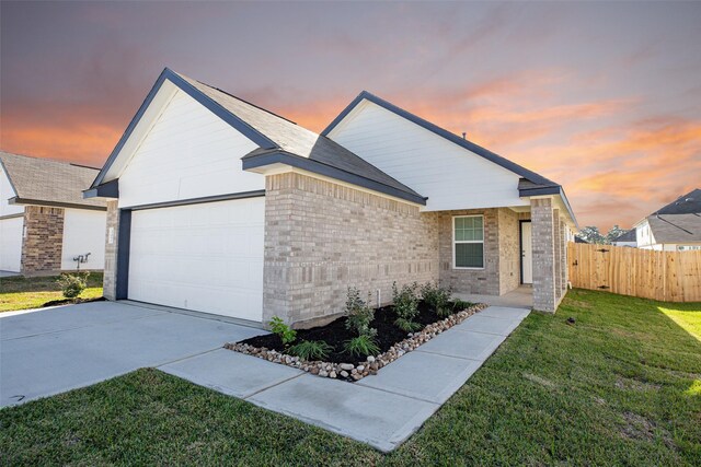 single story home with a yard and a garage