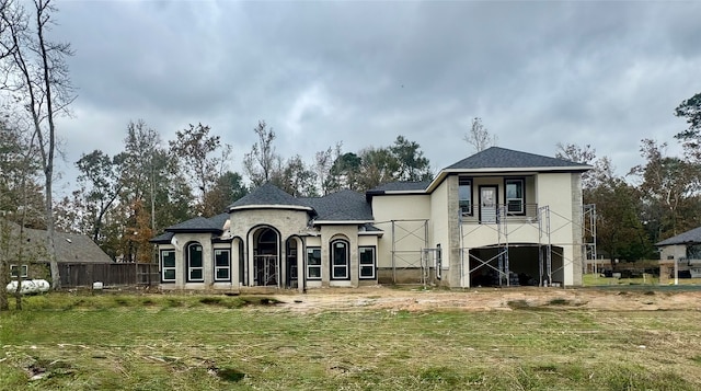 rear view of property with a yard