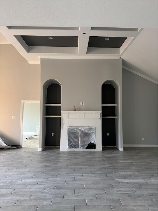 unfurnished living room featuring built in shelves