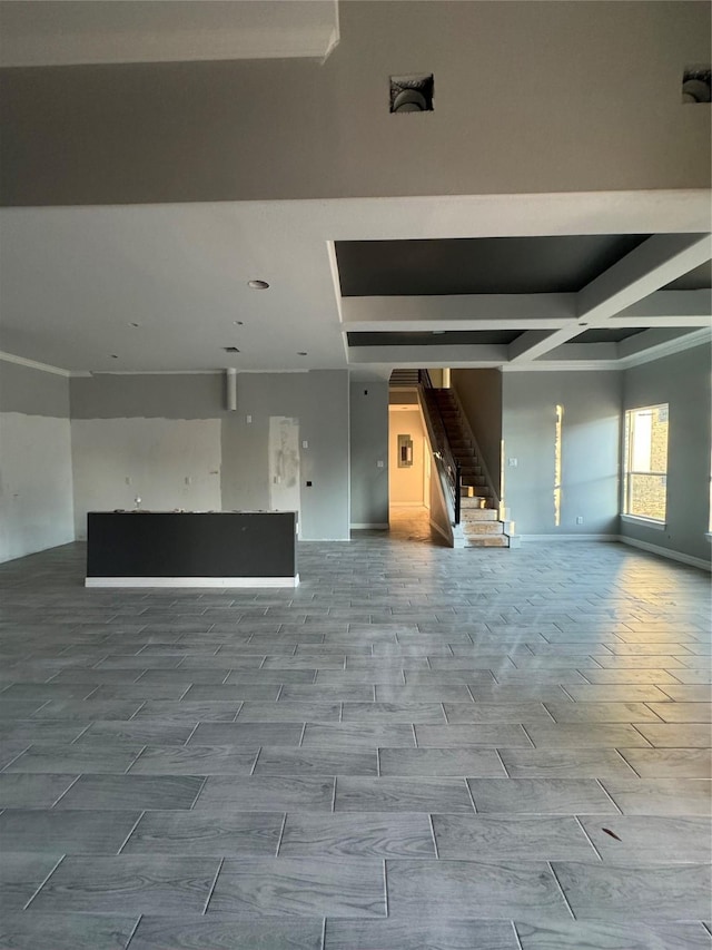 unfurnished room with beamed ceiling and coffered ceiling