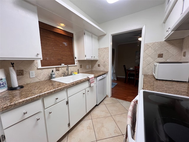 kitchen with white appliances, sink, white cabinets, and tasteful backsplash