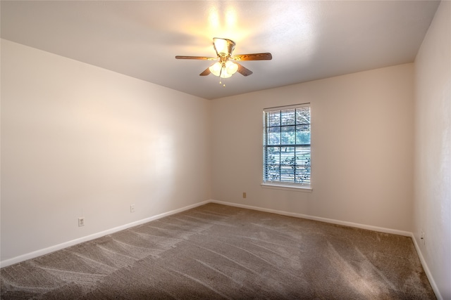 unfurnished room with ceiling fan and carpet flooring