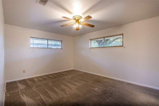 carpeted spare room with ceiling fan