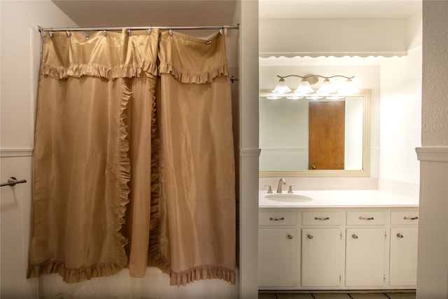 bathroom featuring vanity and curtained shower