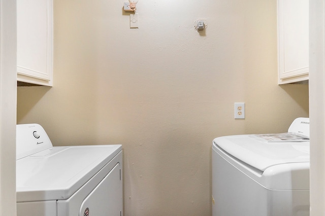 laundry room featuring cabinets and washing machine and clothes dryer