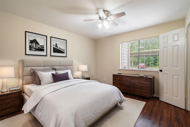 bedroom with dark hardwood / wood-style floors and ceiling fan