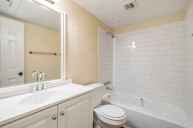 full bathroom with vanity, toilet, and tiled shower / bath