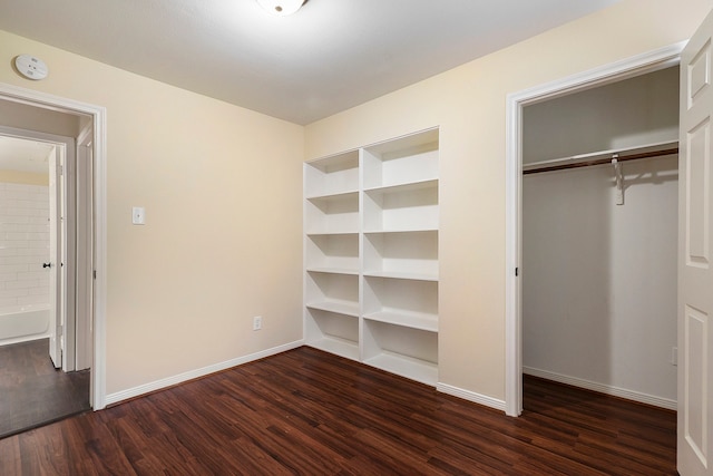 unfurnished bedroom with dark hardwood / wood-style flooring