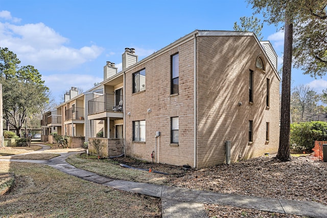 view of side of property featuring a balcony