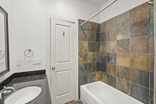 bathroom featuring vanity and tiled shower / bath