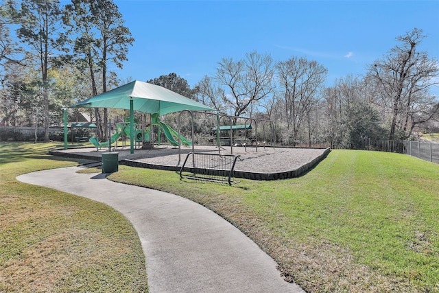 view of property's community with a playground and a yard